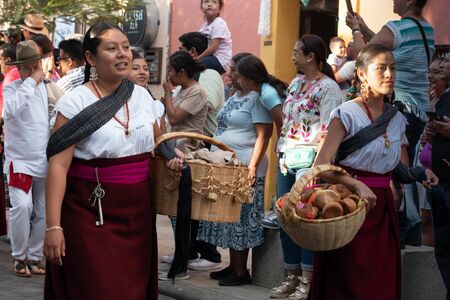 OAXACA, OAXACA, MEXICO- JULY 6, 2019: Young women dressed with traditional clothes during the Convite, a party made for invite to a big traditional party called Guelaguetza in Oaxaca, Mexicoのeditorial素材