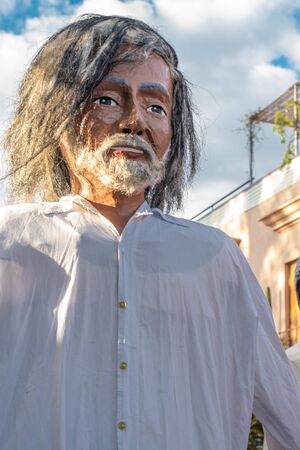 OAXACA, OAXACA, MEXICO- JULY 6, 2019: Giant puppet dressed as the painter Francisco Toledo during the Convite, a party made for invite to a big traditional party called Guelaguetza in Oaxaca, Mexicoのeditorial素材