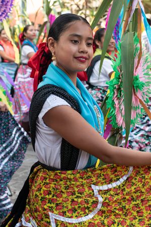 OAXACA, OAXACA, MEXICO- JULY 6, 2019: Girl dressed with traditional clothes during the Convite, a party made for invite to a big traditional party called Guelaguetza in Oaxaca, Mexicoのeditorial素材