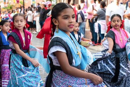 OAXACA, OAXACA, MEXICO- JULY 6, 2019: Little girls dressed with traditional clothes during the Convite, a party made for invite to a big traditional party called Guelaguetza in Oaxaca, Mexicoのeditorial素材