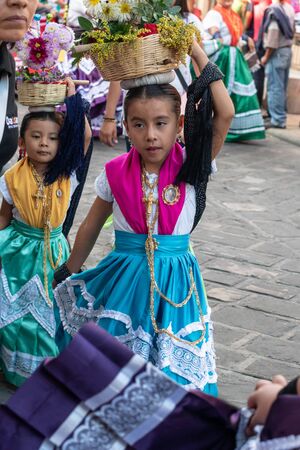 OAXACA, OAXACA, MEXICO- JULY 6, 2019: Little girl dressed with traditional clothes during the Convite, a party made for invite to a big traditional party called Guelaguetza in Oaxaca, Mexicoのeditorial素材