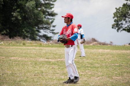 EL CONEJO, PEROTE, VERACRUZ, MEXICO- JULY 14, 2019: Catcher alert for catching a ball in a cloudy day during a baseball game at El Conejo, Perote, veracruz, Mexicoのeditorial素材