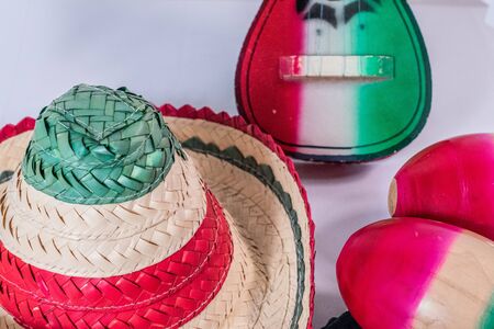 Hat, toy guitar and maracas on white background. Decoration for Mexican Independence Dayの写真素材