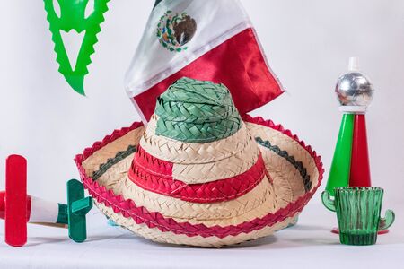 Matraca, hat, mexican flag, cornet and glass of tequila on white backgroundの写真素材
