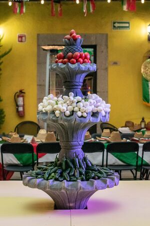 PEROTE, VERACRUZ, MEXICO- SEPTEMBER 15, 2019: Water fountain decorated with tomatoes, spring onions and chili peppers at Mexican Independence Day in Perote, Veracruz, Mexicoのeditorial素材
