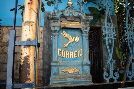 RIO DE JANEIRO, BRAZIL- OCTOBER 13, 2019: Vintage metallic blue mailbox with a dove and text that says "mail" in Portuguese at a house in Rio de Janeiro, Brazilのeditorial素材