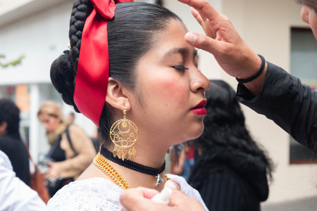 XALAPA, VERACRUZ, MEXICO- NOVEMBER 24, 2019: Young woman with traditional clothes being made up...