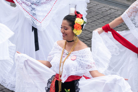 XALAPA, VERACRUZ, MEXICO- NOVEMBER 24, 2019: Young woman dancing and dressed with traditional...