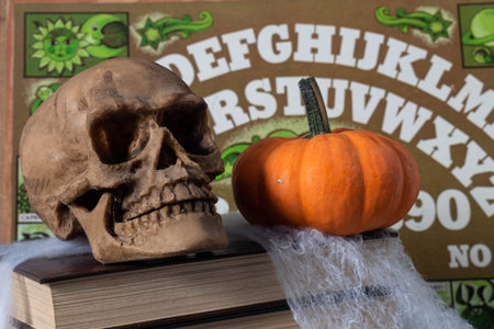 XALAPA, VERACRUZ, MEXICO- OCTOBER 8, 2020: Skull, little pumpkin, books, spider web and Ouija board...
