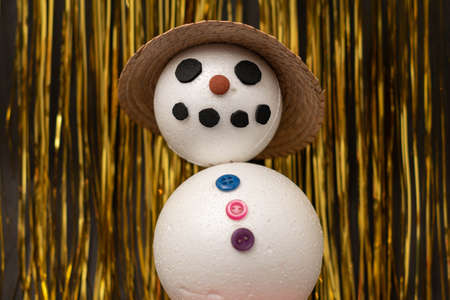 Happy snowman with a hat on golden background. Christmas decorationの写真素材