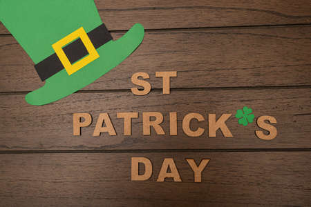 "St. Patrick's Day" made from wooden letters and leprechaun hat on wooden backgroundの写真素材