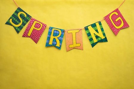 Colorful hand painted spring banner on yellow background. Spring decoration