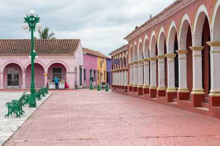 TLACOTALPAN, VERACRUZ, MEXICO- AUGUST 21, 2021: Typical street view at Tlacotalpan downtown with colorful houses in a cloudy dayのeditorial素材