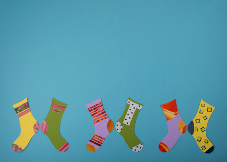 World Down Syndrome Day concept. Different socks made from paper on blue background. Flat lay, top view. Copy space.の写真素材