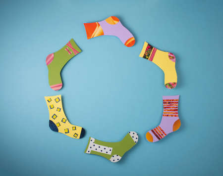 World Down Syndrome Day concept. Different socks made from paper on blue background. Flat lay, top view. Copy space.の写真素材