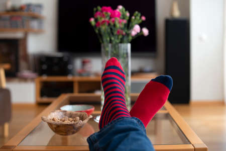 Feet in red socks resting on the table. Close up. Resting concept.の写真素材