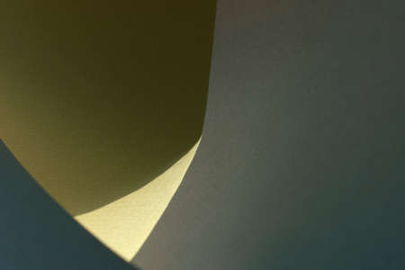 Macro image of green, blue and yellow paper with shadow effect and selective focus. Abstract geometric background. Copy space.の写真素材