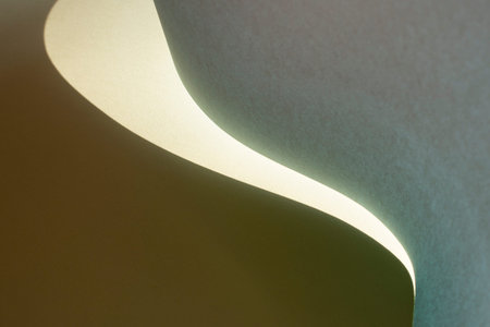 Macro image of green paper with shadow effect and selective focus. Abstract geometric background....