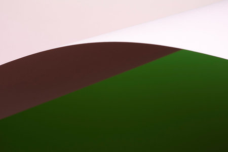 Colour paper geometric shape. Green and pink paper with shadow effect and selective focus. Abstract...