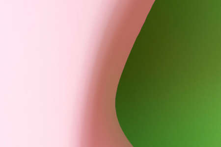 Colour paper geometric shape. Green and pink paper with shadow effect and selective focus. Abstract background. Copy space.の写真素材