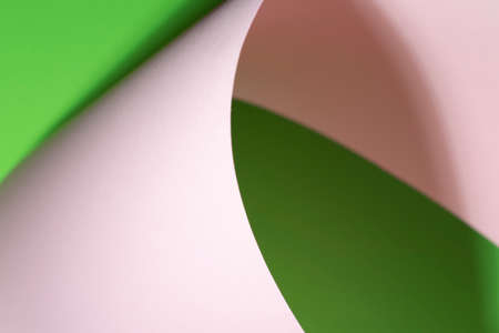 Colour paper geometric shape. Green and pink paper with shadow effect and selective focus. Abstract background. Copy space.の写真素材