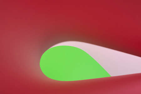 Colour paper geometric shape. Green and red paper with shadow effect and selective focus. Abstract background. Copy space.の写真素材