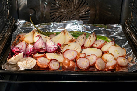 Roasted onions and garlic in the oven. Concept of healthy eating.