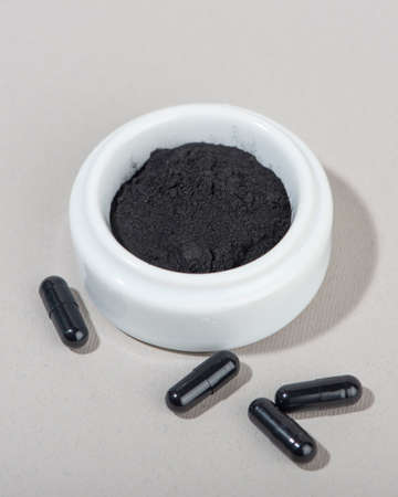 Activated charcoal powder for facial mask. Natural beauty treatment and spa. Beauty concept. Close up.の写真素材