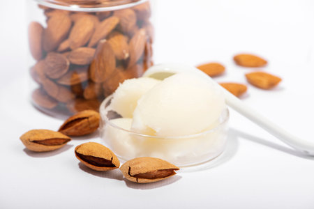 Sweet almond butter and natural almonds on white background. Organic cosmetic, skin care, spa...