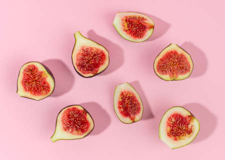 Fresh fig fruits isolated on pink background. Table top view.の写真素材