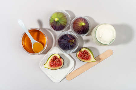 Fresh fig fruits, honey and yogurt, table top view.の写真素材