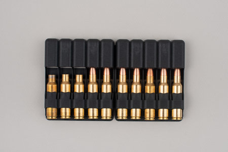 Rifle bullets in plastic cases isolated on grey background.
