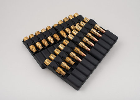Rifle bullets in plastic cases isolated on grey background.