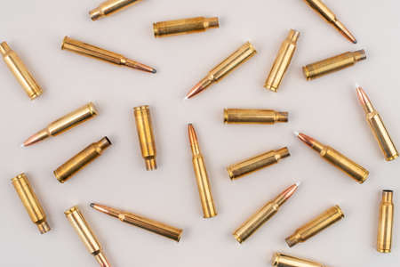 Pile of rifle bullets isolated on grey background. Top view.の写真素材