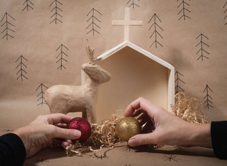Minimal eco Christmas concept. Womens hands holding hand made decorations. Preparation for Christmas holidays.の写真素材
