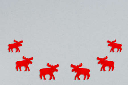 Snow grey background with red moose silhouettes border. Minimalist Christmas background.の写真素材