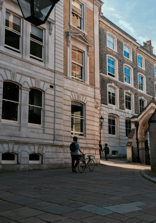 Man walking by his bike in London