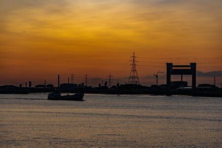Sunset sunrise on the River Thames with a passing shipの写真素材