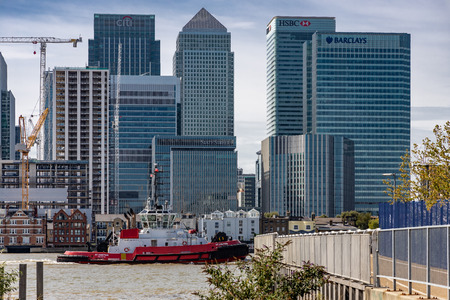 Cityscape of London from across the River Thames showing a passing boatのeditorial素材