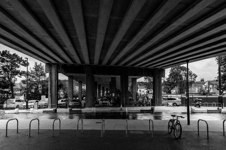 Black and white under the bridge bypass showing an empty bicycle park bayのeditorial素材