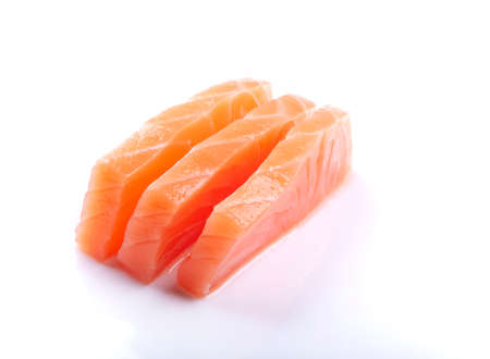 three pieces of raw salmon sashimi sushi japanese food close up cut isolated on white backgroundの写真素材