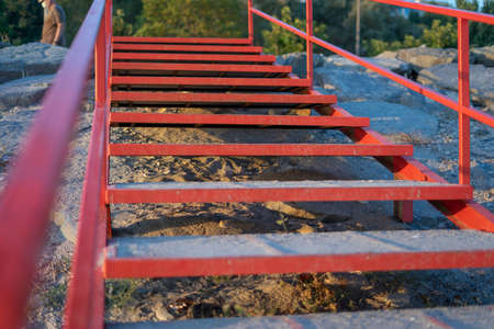 Beach stairs with red metal railingの写真素材