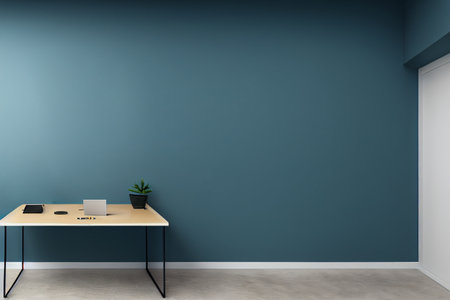 Minimalist office interior with blue walls, concrete floor, computer desk and plant. 3d renderingの写真素材