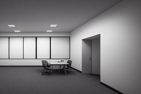 Interior of modern office with white walls, concrete floor, rows of white computer tables and open door. 3d renderingの写真素材