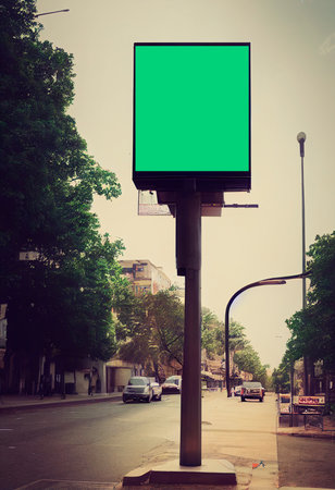 billboard with green screen on city street, retro toned imageの写真素材