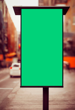 Blank green signboard on a city street. Mock up.の写真素材