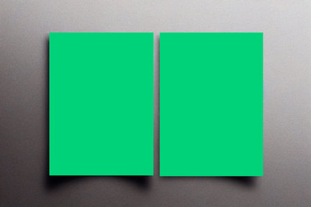 Blank green business card on a gray background. Mock up.