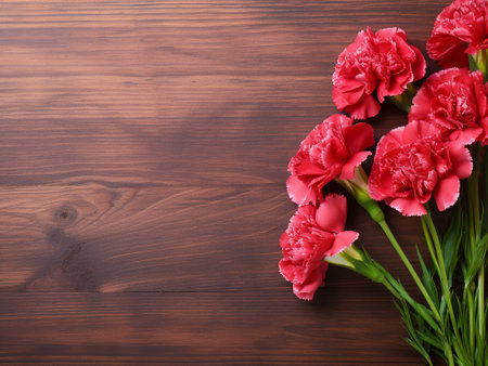 bouquet of red carnations on wooden background with copy spaceの写真素材