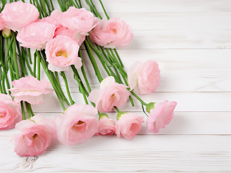 Bouquet of pink flowers on white wooden background. Top view with copy spaceの写真素材