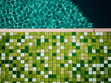Swimming pool with green tiles and water reflection. Top view.